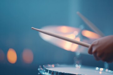 Poster - close-up of drummer hands gripping brushes and snare caught in mid-sweep motion under ambient light