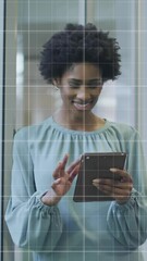 Poster - Animation of financial data processing over african american businesswoman using tablet