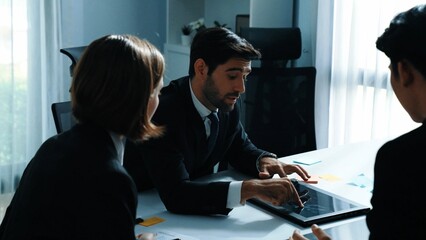 Poster - Back view of businessman working on laptop while team analysis data. Skilled marketing team writing marketing idea at meeting room. Group of diverse people brainstorm financial idea. Directorate.