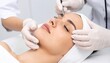 © photostockatinat - Aesthetic skincare treatment being performed on a female patient. The scene shows a close-up of the patient's face, with her eyes closed in relaxation, while professional hands perform the procedure.