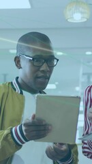 Poster - Male and female colleagues using laptop and tablet, having business talk in office