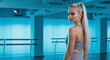 © Vasiliy - Woman with a very long straight platinum blonde ponytail, grey sports bra, in a modern fitness studio. Sleek athletic style for gym promotions, activewear, or long hairstyle showcases for sport