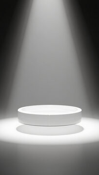 Clean Minimalist White Product Display Platform; Dramatic Spotlight, Modern Studio Setting.