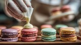 cooking, food and baking concept - chef with confectionery bag squeezing cream filling to macarons shells at pastry shop, no logos, no brands