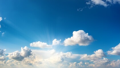 Wall Mural - a bright blue sky with soft clouds and warm sunlight