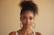 © Viktor - Stylish woman, curly ponytail hairstyle, wearing big gold earrings and natural makeup. Fashionable look with elegant jewelry and flawless skin emphasizes beauty and personal style.