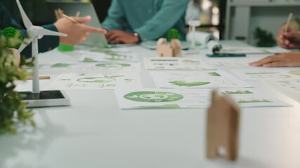 Poster - A vibrant scene showcasing professionals engaged in collaborative work on sustainable energy solutions. Papers, charts, and green design elements highlight eco-friendly innovation and teamwork. SACTR