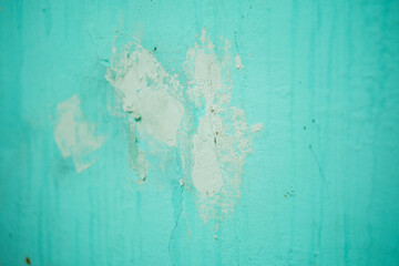 Poster - Close-up of weathered wall texture shows repairs on painted surface, creating an abstract pattern. Ideal for backgrounds conveying age, renovation, or artistic expressions of decay and resilience.