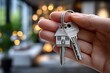 © Multiverse - New homeowner holds house keys in hand inside modern living room with warm lights