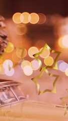 Poster - Animation of glowing stars falling over christmas decorations with pine cone on model car