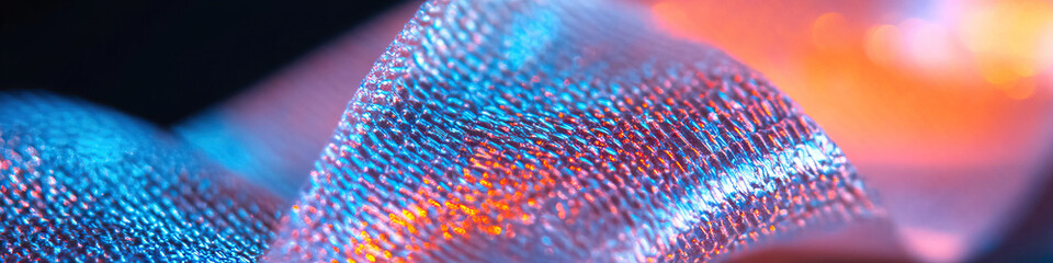 Poster - Close-up of Textured Metallic Material with Blue and Orange Lighting