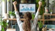 © SOEM - Businesswoman celebrating success with arms raised over a laptop showing positive free cash flow