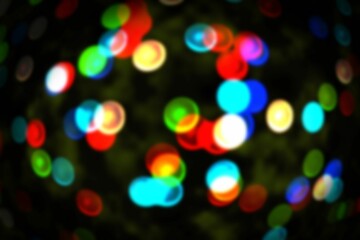 Poster - Cluster of defocused colored light circles is floating in bokeh effect over dark backdrop