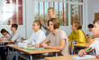 © JackF - Group of diligent school kids and teacher during lesson in classroom in secondary school