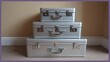 © Boonnam Burart - Set of three matching silver suitcases stacked in size order