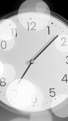 Poster - Animation of clock ticking over spots of light on black background