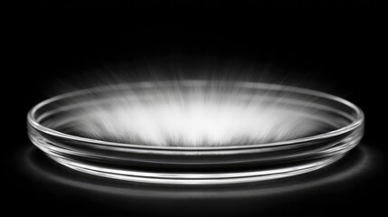 Poster - Abstract Glass Dish with Soft Light Effects Creating a Mystical Atmosphere on a Black Background for Artistic and Culinary Use in Photography and Design