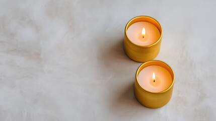 Poster - Tranquil Scene with Two Yellow Candles on a Soft Gray Background, Creating a Calming Atmosphere for Relaxation, Meditation, or Home Decor