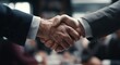 © Init - close - up of a man's handshake. two men shaking hands in a meeting room. a man wearing a suit and tie