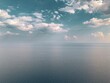 © Wirestock - Serene ocean view with soft clouds.