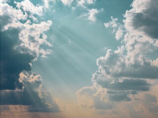 Wall Mural - Sunbeams through clouds in a serene sky.