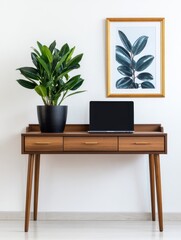 Poster - Modern workspace featuring a wooden desk with a laptop, plant, and framed art on the wall