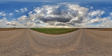 Wall Mural - hdri 360 panorama view on gravel road among fields with clouds in sky in equirectangular full seamle