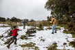 © Austockphoto - Boys throwing snow at their dad