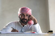 © Jack Tamrong - Arabic architect man in traditional Arab cloth and headscarf thinking about work in construction site