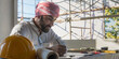 © Jack Tamrong - Arabic architect man in traditional Arab cloth and headscarf thinking about work in construction site