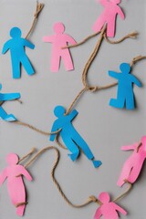 Leinwandbilder - Paper figures connected by rope symbolize unity and equality among diverse individuals in vibrant colors