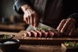 © Chin - Close up shot medium rare steak cut on wooden cutting board, Selective focus chef hand with sharp knife sliced steak for serve in steak house restaurant.