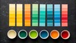 © PixelNest - Colorful paint samples are neatly arranged with paint cups, showcasing a wide spectrum of shades for art and design projects.