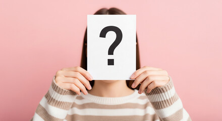 Poster - Woman holding paper with question mark obscuring face, against pink background.  Illustrates anonymity, uncertainty, or question concept
