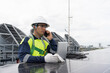 © amorn - Solar panel rooftop, Rooftop solar power. Engineer using laptop computer inspecting installation and control quality of solar panel on rooftop of building