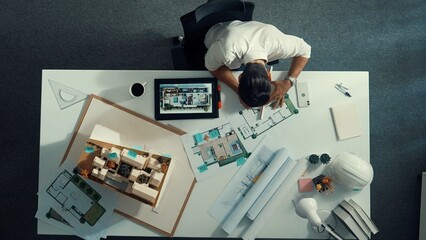 Poster - Top view of smart business woman walking and give house design. Aerial view of architect engineer looking at blueprint and building structure at table with safety helmet and house model. Alimentation.