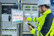 © reewungjunerr - Electrical engineer woman checking voltage at the Power Distribution Cabinet in the control room,preventive maintenance Yearly,Thailand Electrician working at company