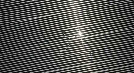 Poster - Sunlight reflecting off modern metal siding creates a captivating interplay of light and shadow, forming a striking pattern across the building's sleek exterior
