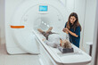 © Dragana Gordic - Patient Receiving an MRI Scan with Technician Offering Reassurance and Support