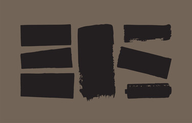 Poster - A collection of seven abstract black brush stroke shapes and rectangles arranged on a muted brown background creating a modern graphic design element
