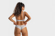 © Pixel-Shot - Beautiful young African-American woman in stylish lace lingerie on white background, back view