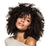 Beautiful curly haired female model with radiant skin and soft makeup looking confident and relaxed isolated on transparent background.