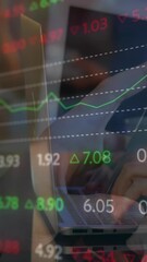 Poster - Animation of trading board, overhead view of cropped hands of caucasian man using smartphone