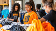 © Supawit - A youth center organizing a clothing drive, where teens are actively sorting donations and helping those in need in the community. —ar 16:9