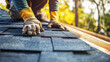 © Keo - A roofer working with roofing underlayment on the roof before laying shingles.