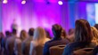 © Stephen - Audience watches presentation on stage with purple lighting