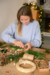 © Franci Leoncio - Woman creating christmas wreath with natural materials