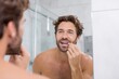 © Vlad - Person in Bathroom: Handsome Young Man Checking Teeth in Mirror