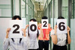 © Creativa Images - Business Team Holding Up '2026' Signs for New Year's Vision