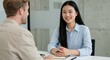 © Habiba - Young asian woman smiles during a job interview with a recruiter